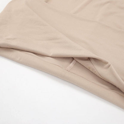 Close-up of soft, cappuccino-toned fabric of the Sculpted Grace Maxi Dress showcasing its smooth texture.
