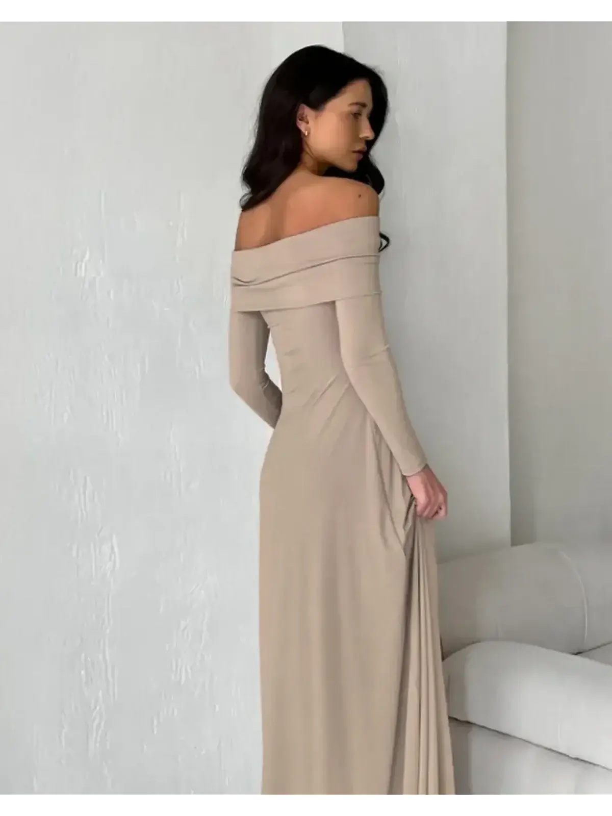 Model showcasing the Sculpted Grace Maxi Dress in cappuccino, featuring an elegant off-shoulder design and sleek silhouette.