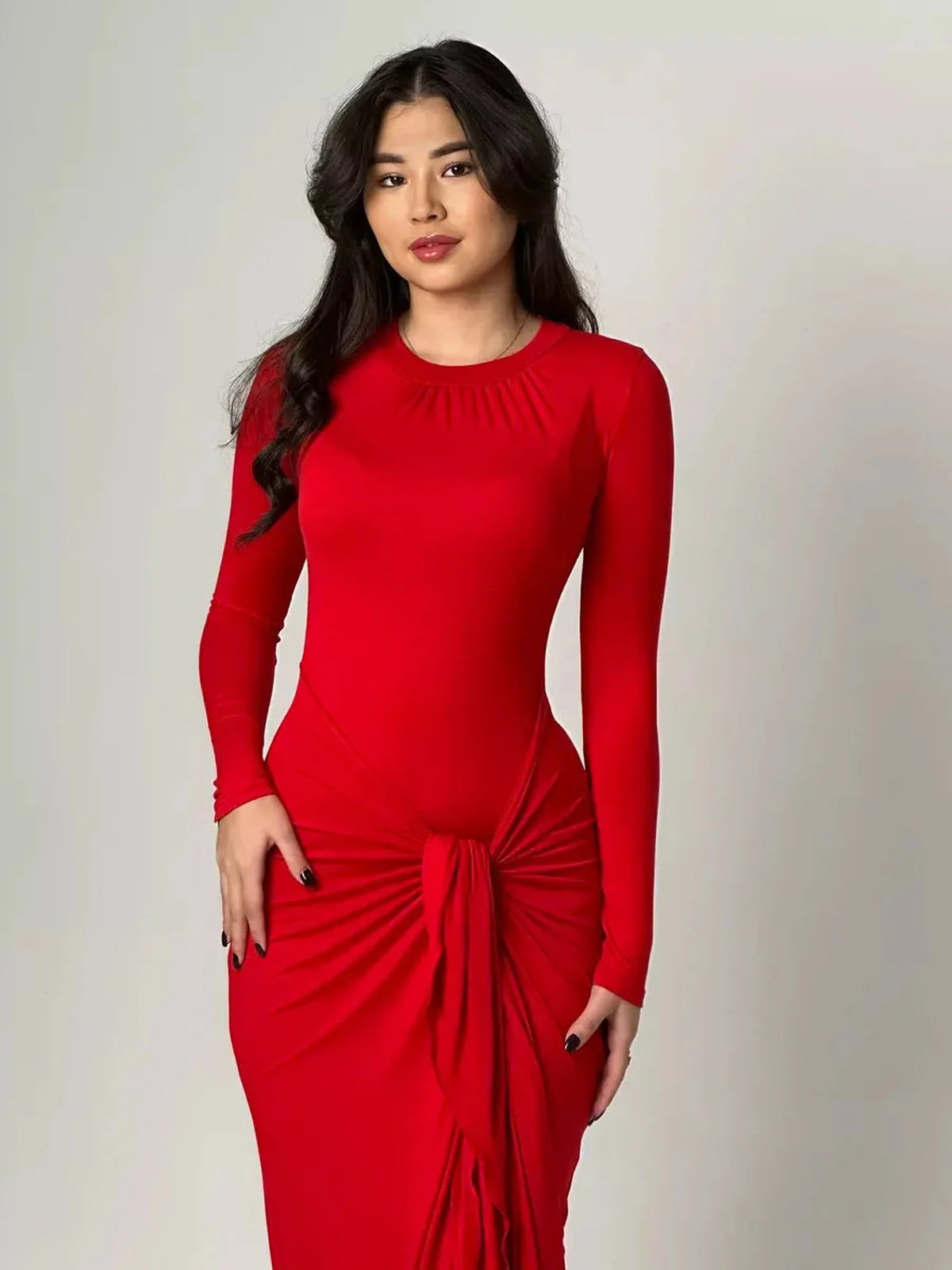 Model wearing the Sculpted Grace Maxi Dress in red, showcasing its silhouette-shaping design and knotted waist detail.