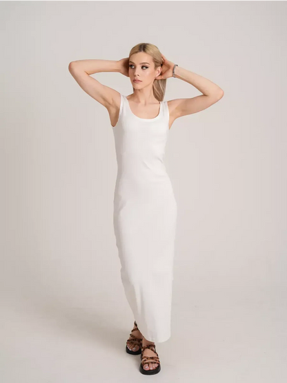 Model showcasing the Sculptura Maxi Dress in white, embodying sleek ribbed elegance and contemporary minimalism.