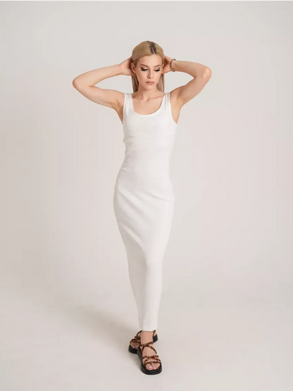 Model in a sleek white Sculptura Maxi Dress showcasing elegant ribbed design and effortless style.