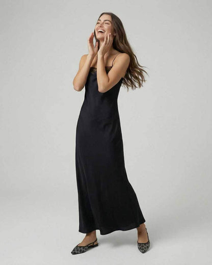Selene Maxi Dress by Lauven worn by a model, showcasing its sleek lace-trimmed design and elegant silhouette.