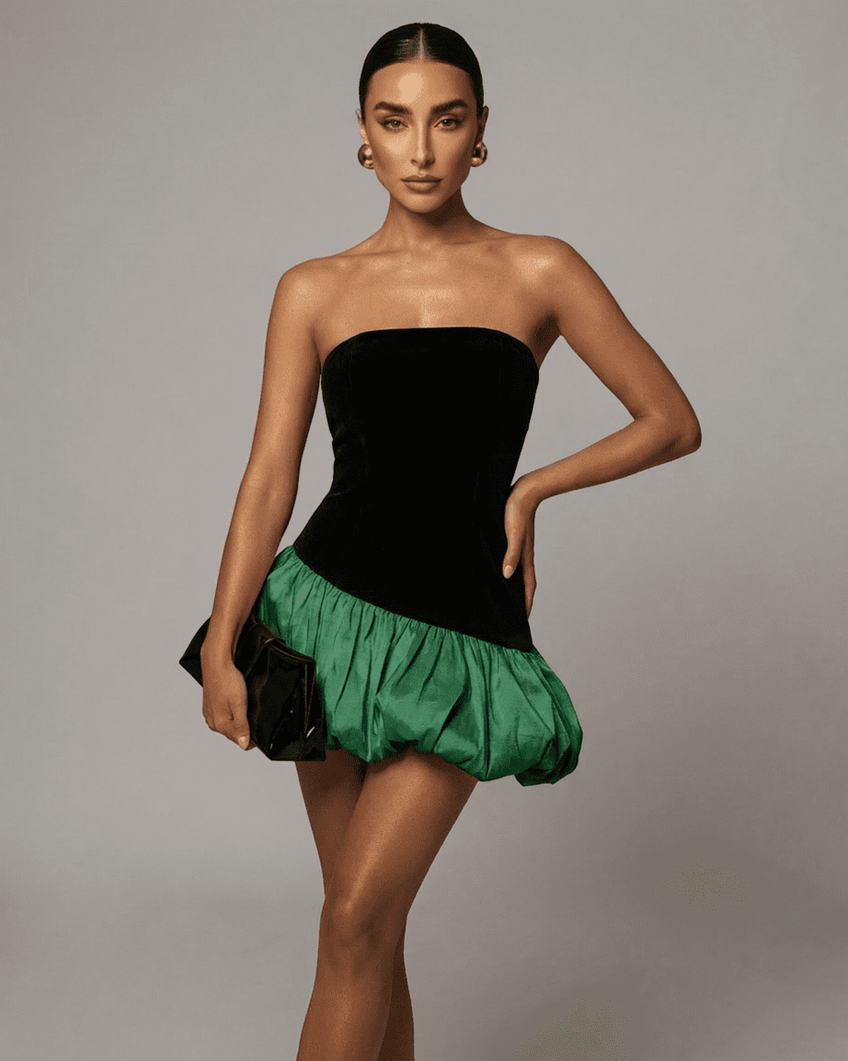 Selina Green Dress by Lauven, featuring a strapless design, black velvet bodice, and green puffed skirt.