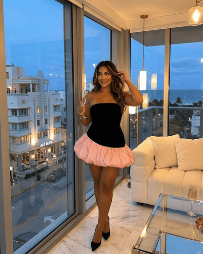 Model showcasing the Selina Mini Dress by Lauven, featuring a strapless velvet bodice and playful pink puff skirt.