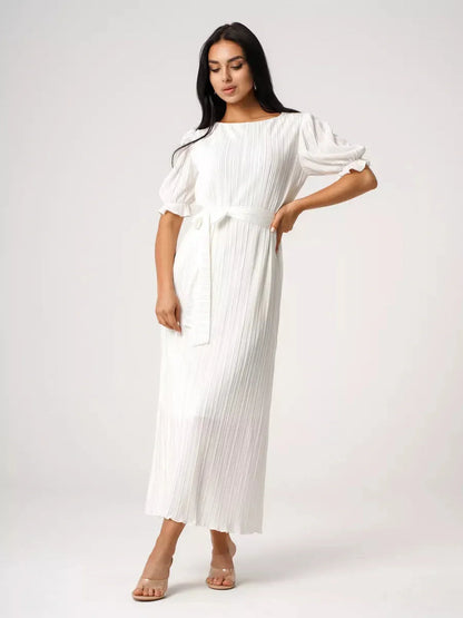 Model showcasing the Seraphine Maxi Dress, a lightweight pleated white dress, perfect for summer elegance.