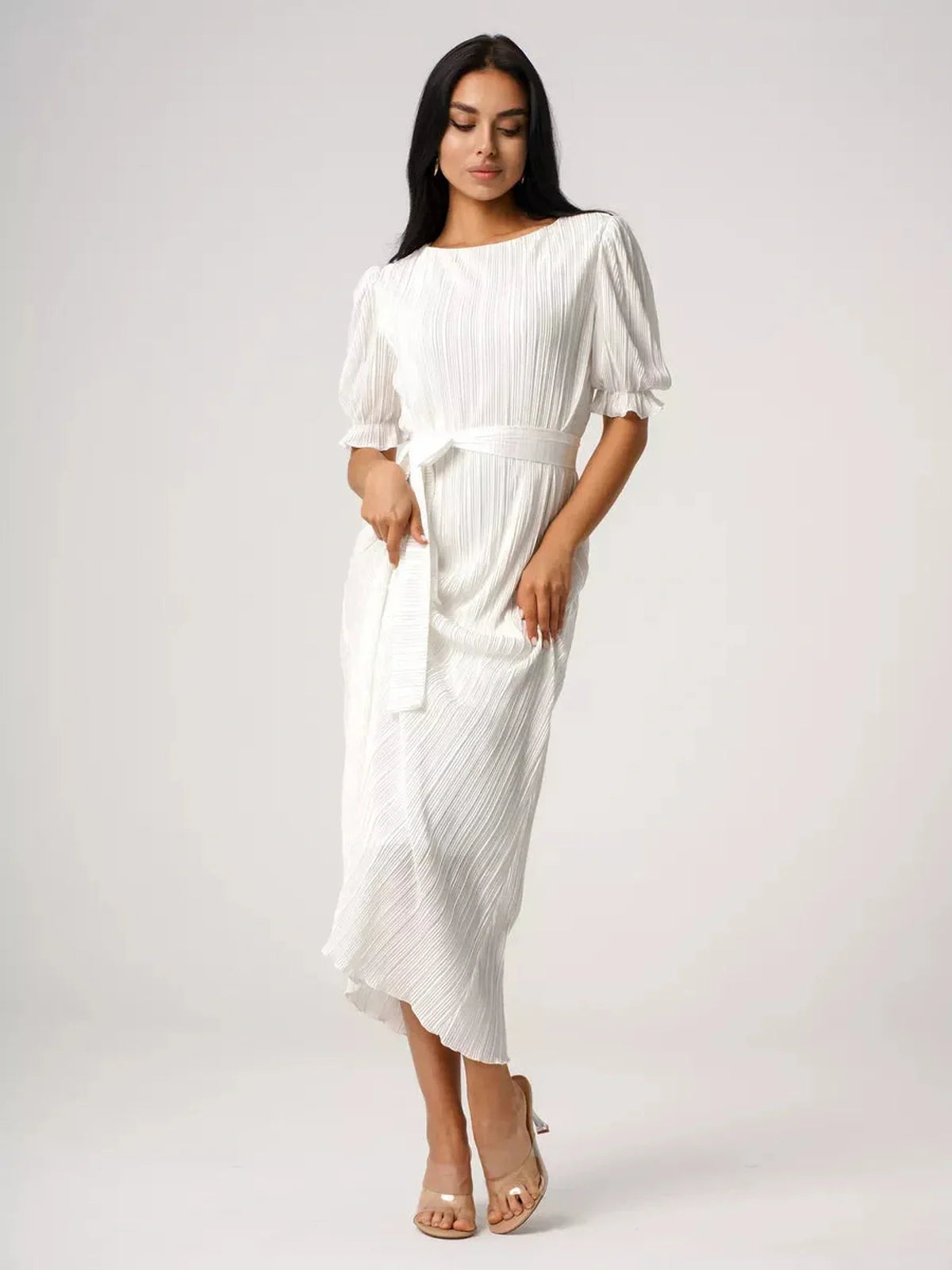 Elegant woman in Seraphine Maxi Dress, showcasing pleated texture and refined silhouette, perfect for summer events.