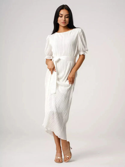 Elegant woman in Seraphine Maxi Dress, showcasing pleated texture and refined silhouette, perfect for summer events.