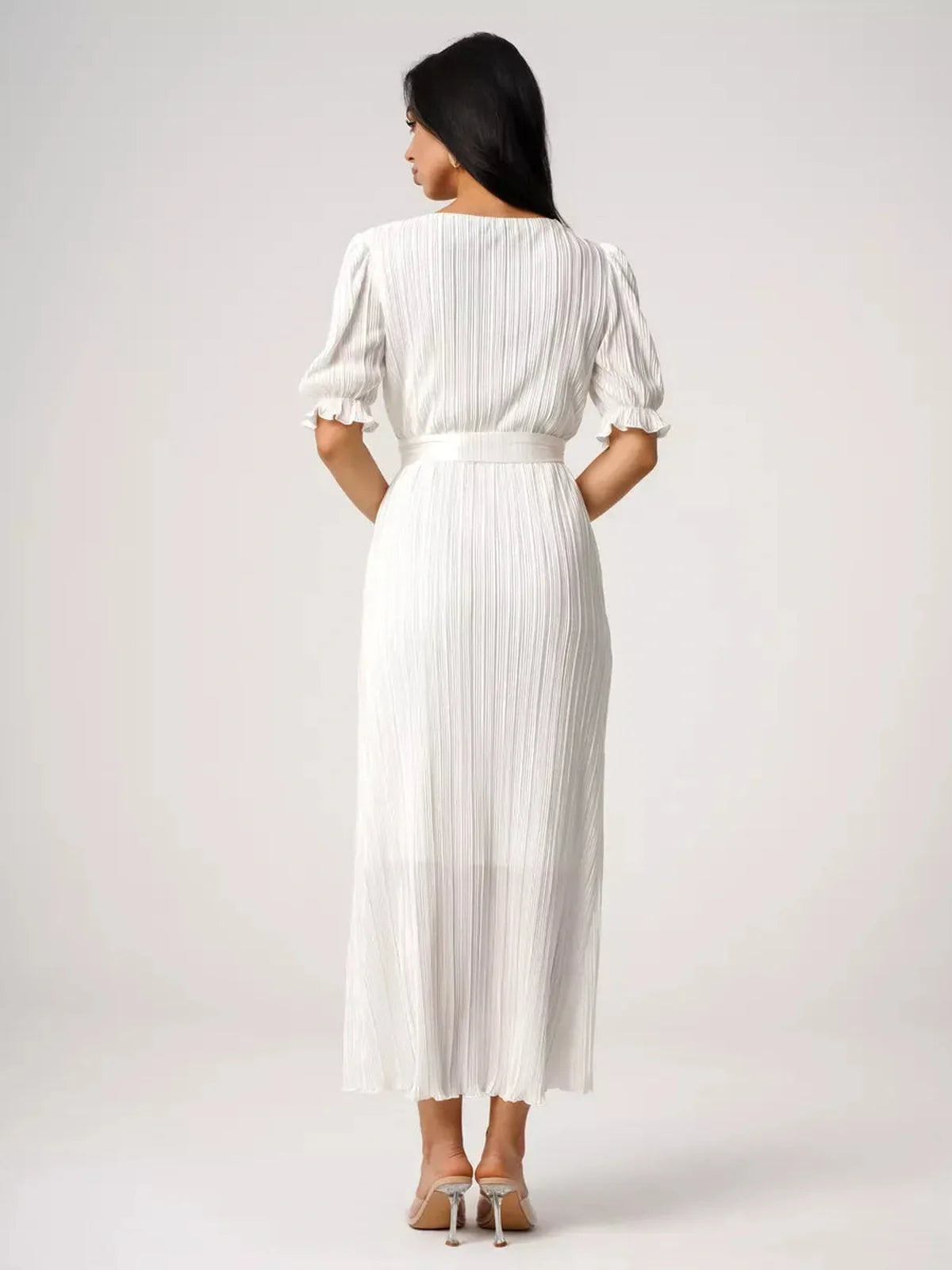 Back view of the Seraphine Maxi Dress showcasing pleated elegance and refined silhouette in lightweight fabric.
