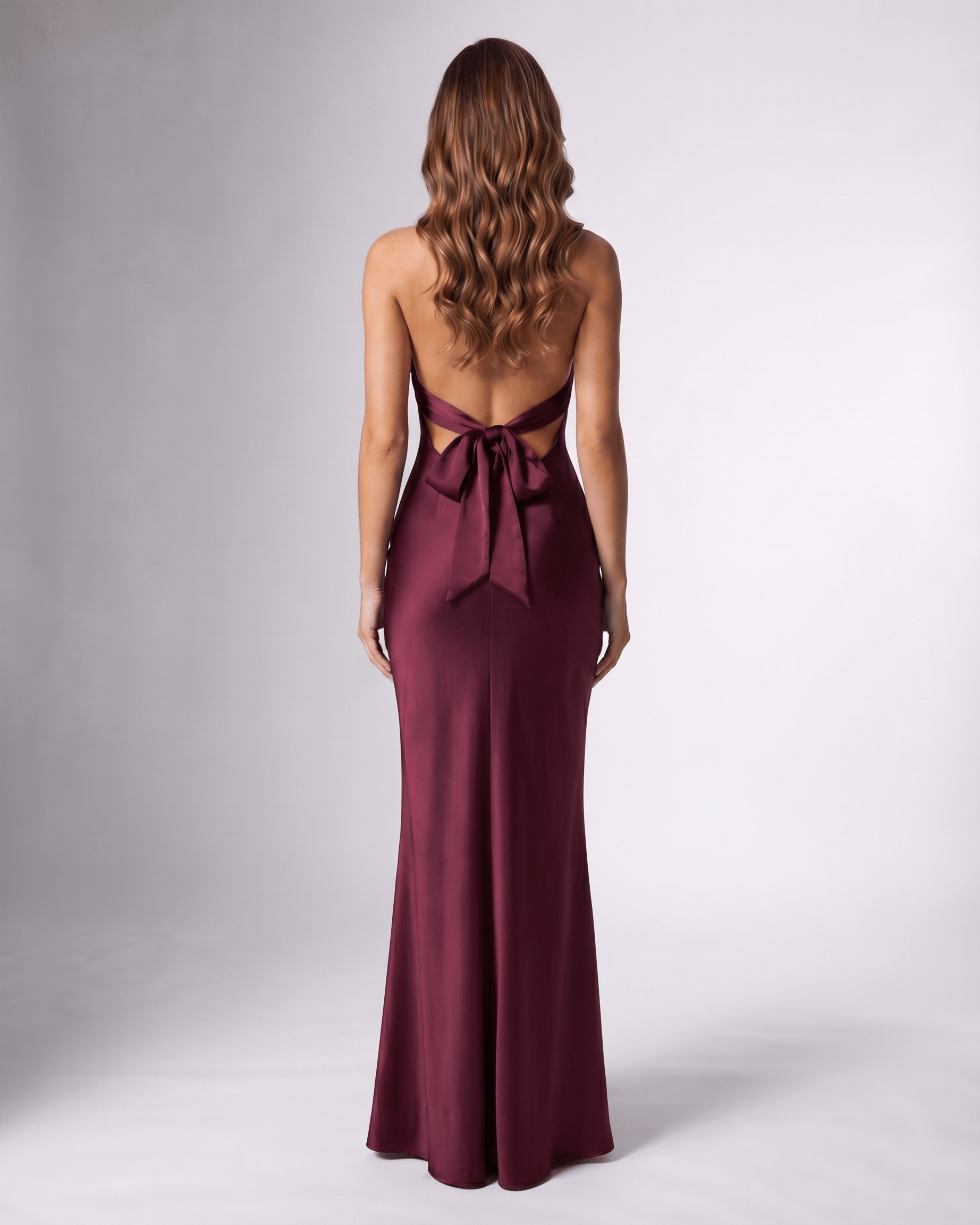 Burgundy satin maxi dress by Lauven, featuring an open back and halter neck design for elegant evening wear.