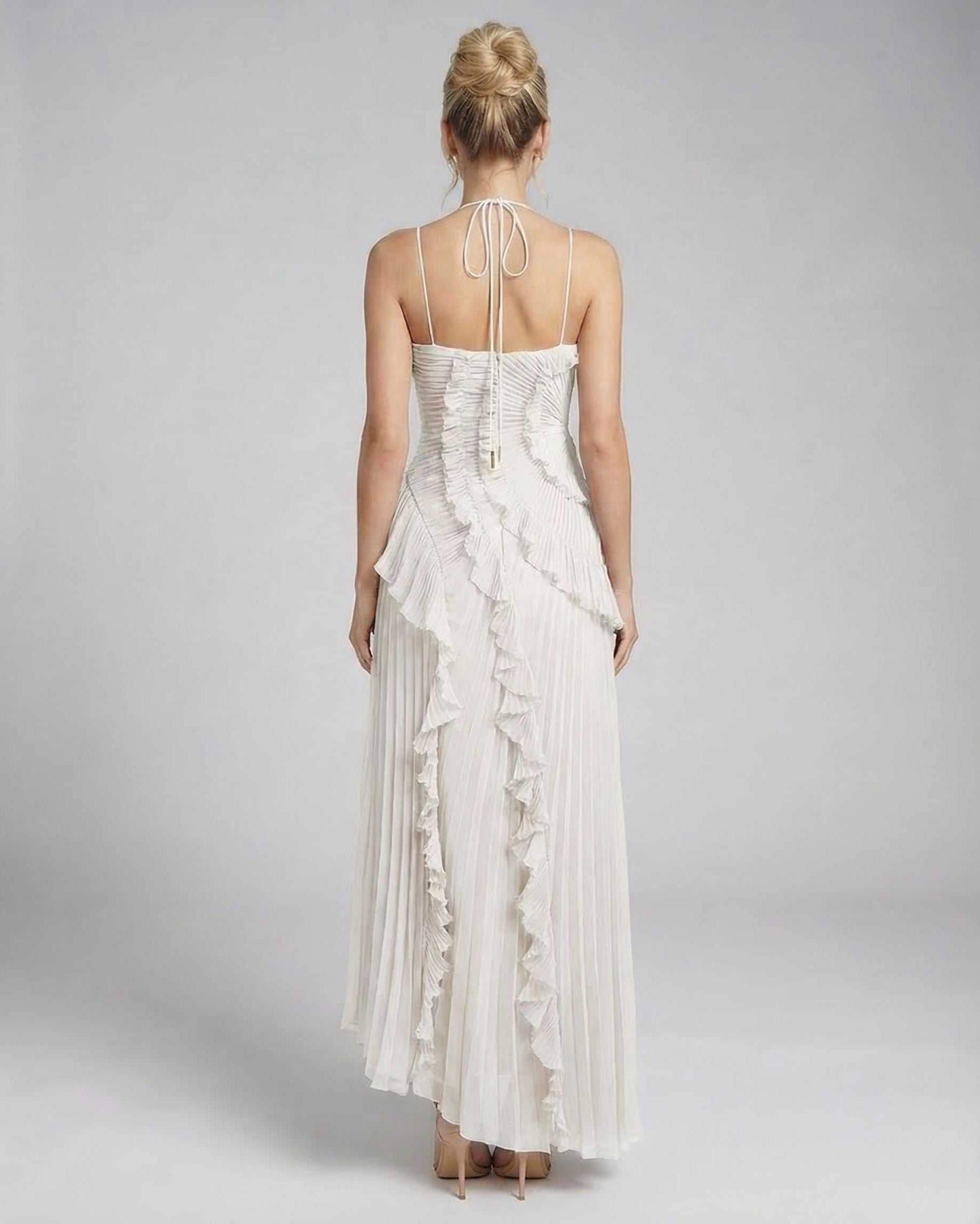 Back view of Seren Maxi Dress by Lauven, showcasing delicate ruffle accents and pleated fabric in classic ivory.