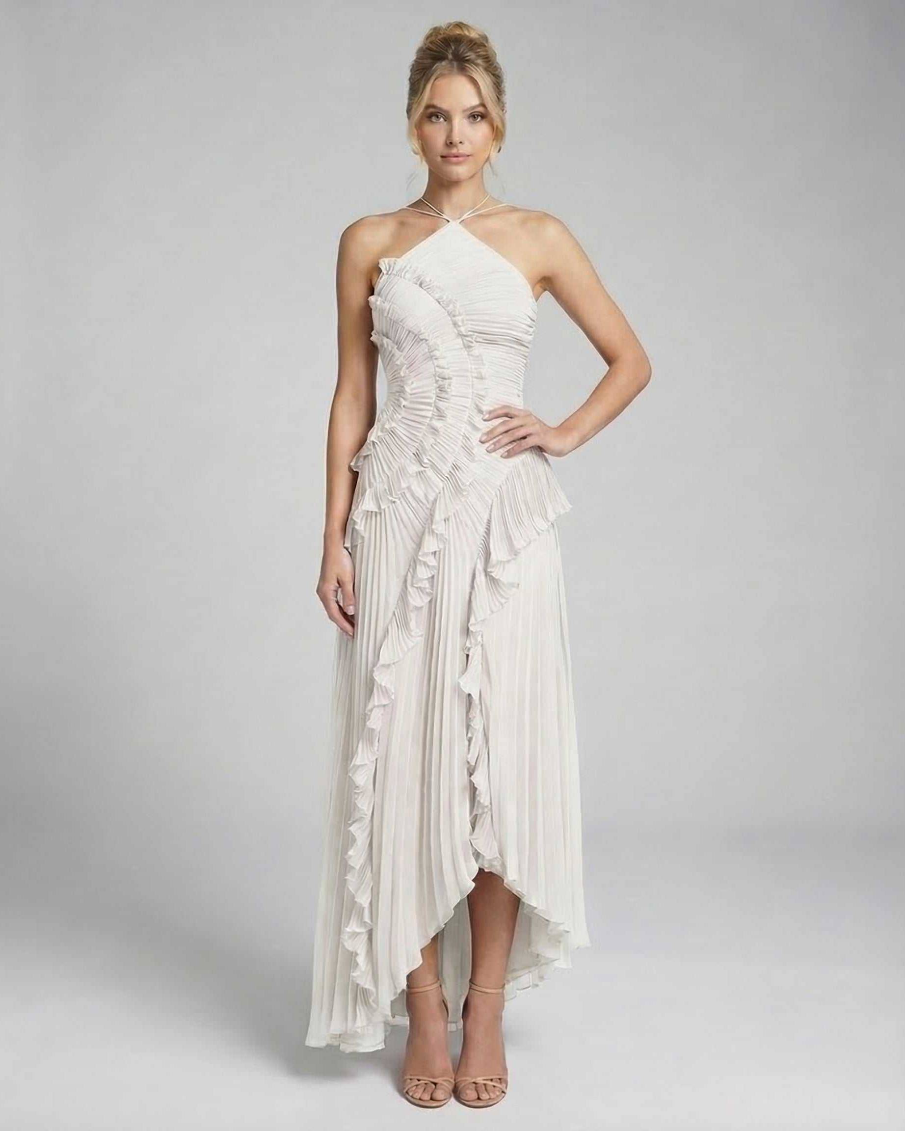Seren Maxi Dress by Lauven, a classic ivory pleated halter gown with ruffles and high-low hem.