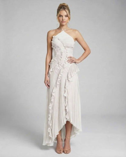 Seren Maxi Dress by Lauven, a classic ivory pleated halter gown with ruffles and high-low hem.