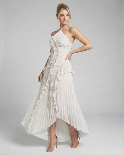 Seren Maxi Dress by Lauven, elegant ivory pleated halter gown with ruffles and high-low hem.