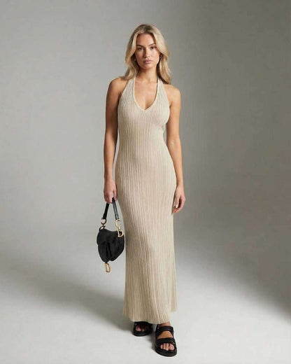 Model wearing the Serena Maxi Dress by Lauven, a sleek V-neck ribbed knit ankle-length dress in beige.