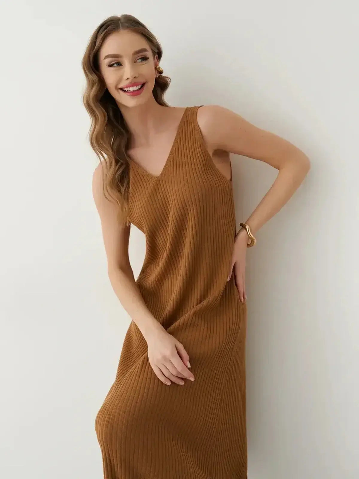 Smiling woman wearing a sleeveless ribbed Serena Maxi Dress in a warm brown shade, showcasing effortless elegance.