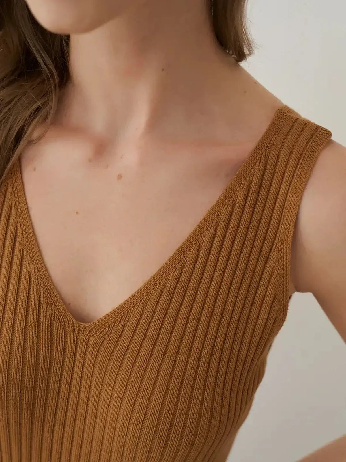 Close-up of the Serena Maxi Dress showcasing its ribbed texture and flattering V-neckline in warm brown.