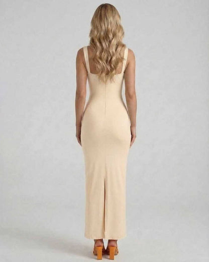 Back view of a woman wearing the Lauven Serena Maxi Dress in soft nude satin fabric, showcasing its elegant silhouette.