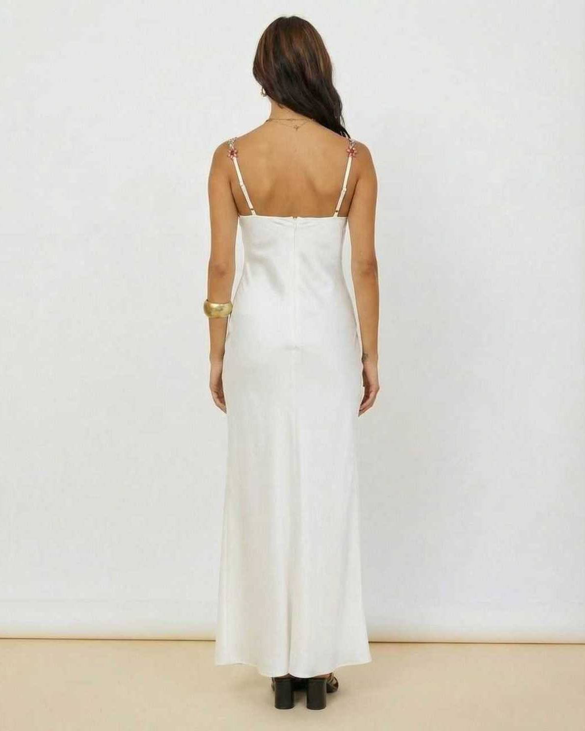 Back view of the Serena Maxi Dress by Lauven, showcasing white satin fabric and floral embroidery details.