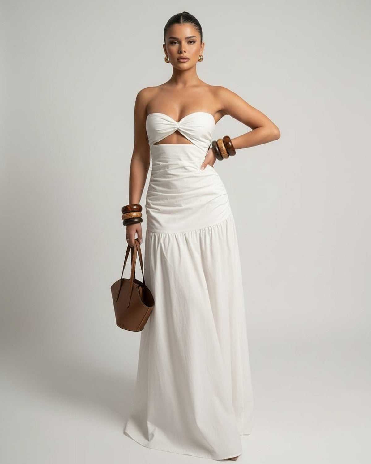 Serena Maxi Dress featuring a white strapless design, high waist cutout, and flowing silhouette from Lauven.