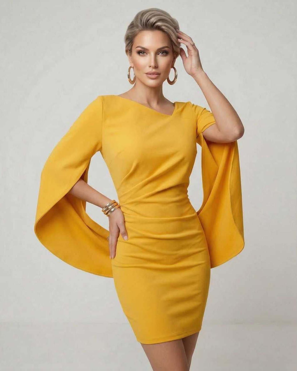 Serena Mini Dress by Lauven in vibrant yellow with sleek cloak sleeves and a flattering sheath silhouette.