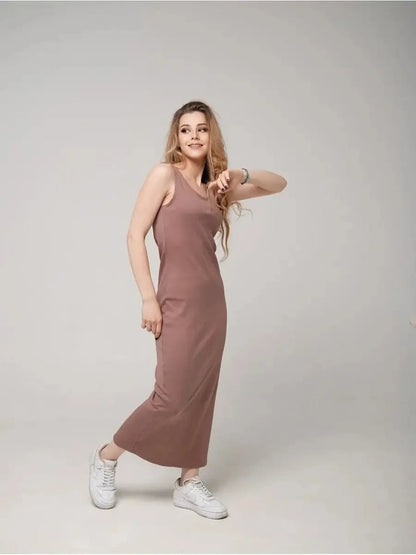 Model wearing Serene Flow Maxi Dress in a warm hue, showcasing relaxed elegance and comfort with stylish sneakers.
