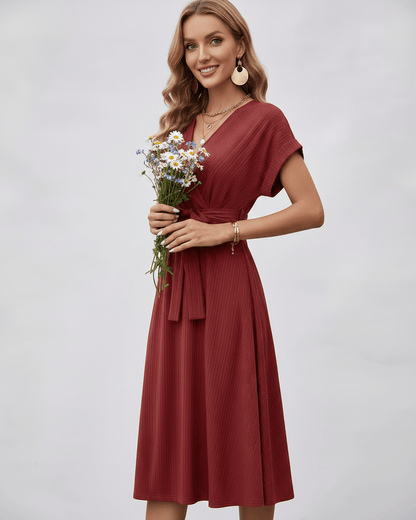 Serene Midi Dress in a warm rust shade, featuring a V-neck and pleated fabric, styled with a self-tie belt by Lauven.