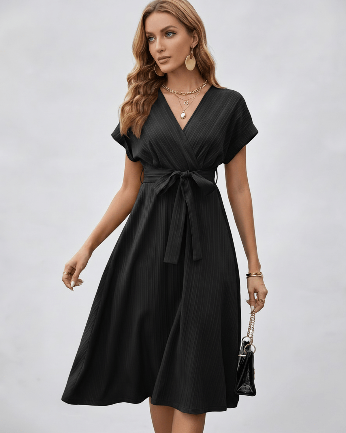 Serene Midi Dress in black, pleated fabric, V-neck, A-line silhouette with self-tie belt by Lauven.