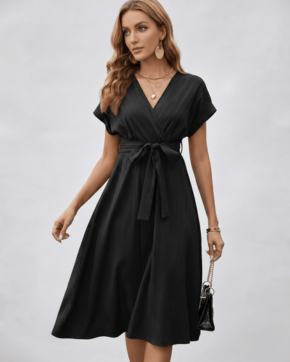 Serene Midi Dress in black, pleated fabric, V-neck, A-line silhouette with self-tie belt by Lauven.