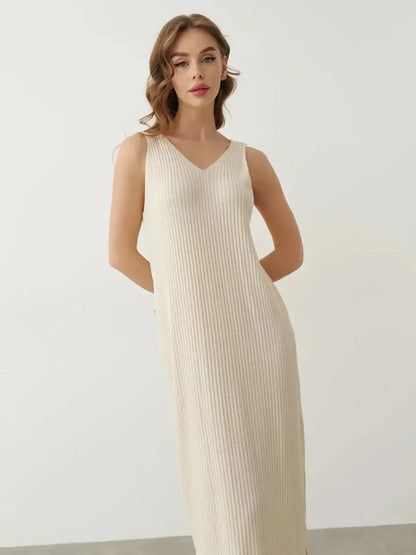 Serene Rib Maxi Dress in soft cream ribbed knit, featuring a V-neckline and elegant ankle-grazing silhouette.