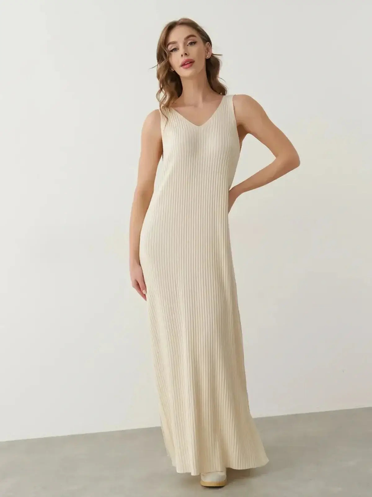 Model showcasing the Serene Rib Maxi Dress in soft knit with a V-neckline and elegant ribbed design.