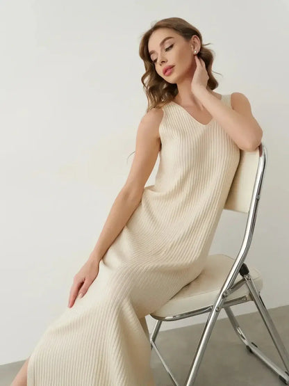 Model wearing the Serene Rib Maxi Dress in a soft knit, showcasing its elegant V-neckline and flowing silhouette.