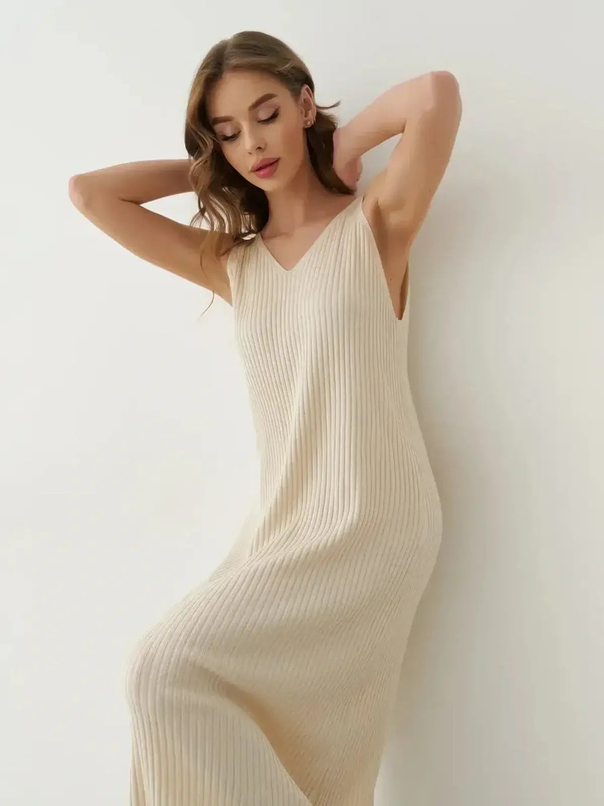 Model showcasing the Serene Rib Maxi Dress in soft ribbed knit, featuring a V-neckline and ankle-length silhouette.