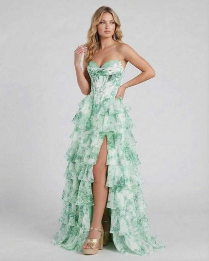 Serenella Maxi Dress by Lauven, featuring a floral tiered chiffon design with a high slit and elegant strapless silhouette.