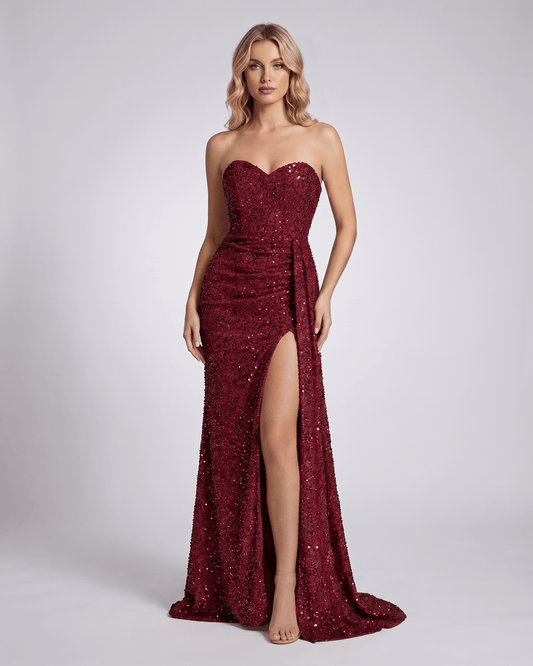 Serenza Maxi Dress in burgundy, strapless, fully embellished, bodycon silhouette, featuring a seductive thigh-high slit.