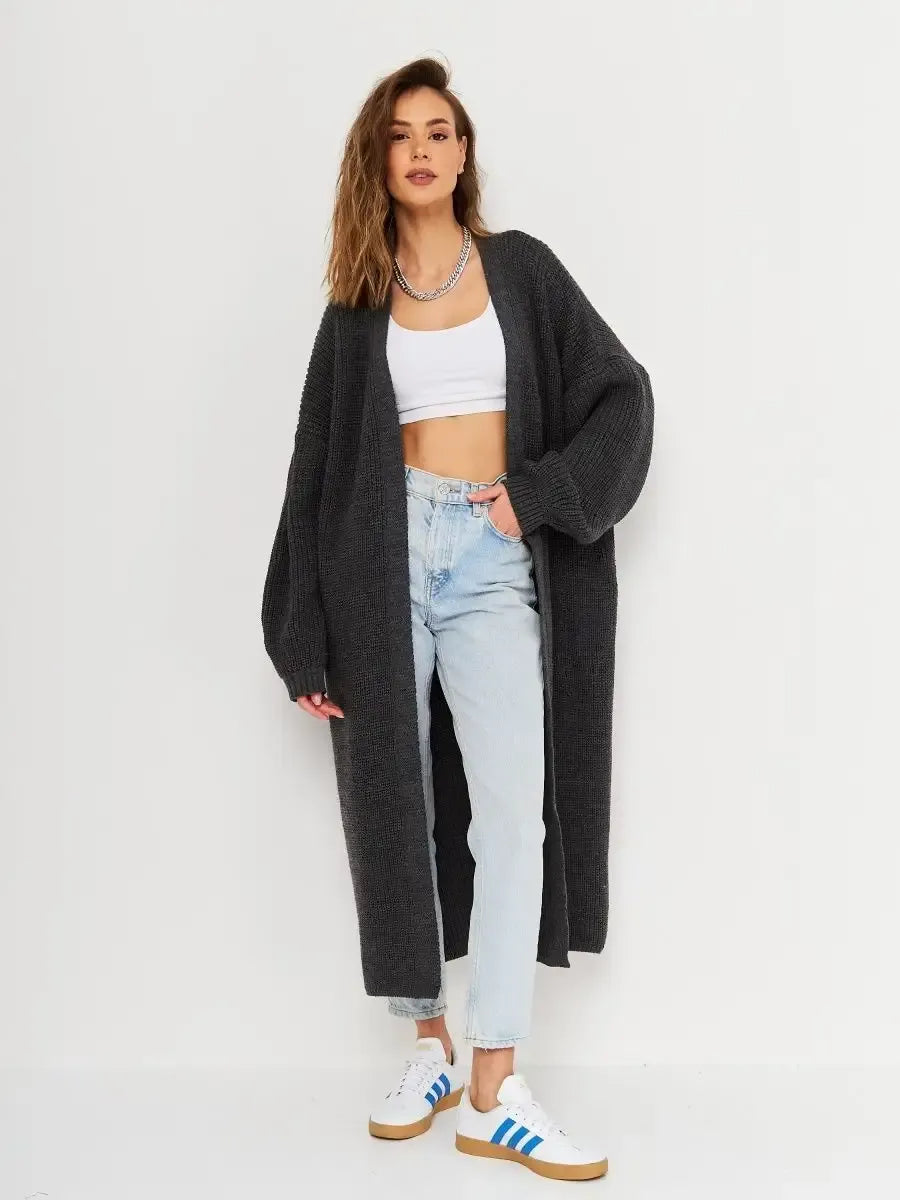 Model wearing the Shadow Cardigan by Lauven, showcasing an oversized gray knitwear coat paired with casual jeans.