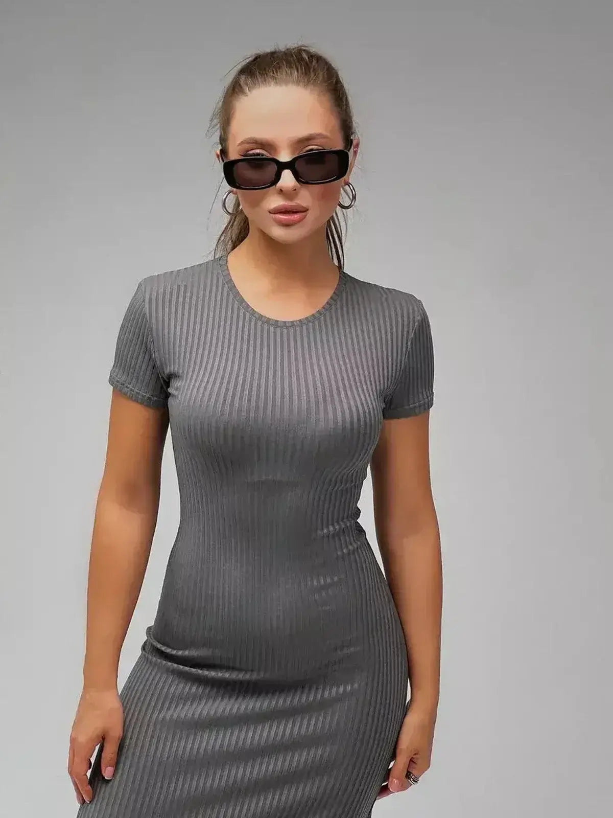 Shadow Curve Maxi Dress in grey ribbed knit, showcasing a sleek silhouette and modern minimalism.