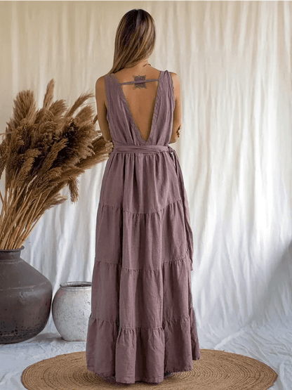 Back view of a woman wearing the Sienna Breeze Maxi Dress in rich mocha, showcasing its tiered design and deep V-neckline.