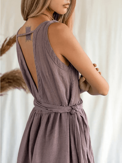 Back view of a woman in a Sienna Breeze Maxi Dress showcasing its deep V-neckline and self-tie belt.