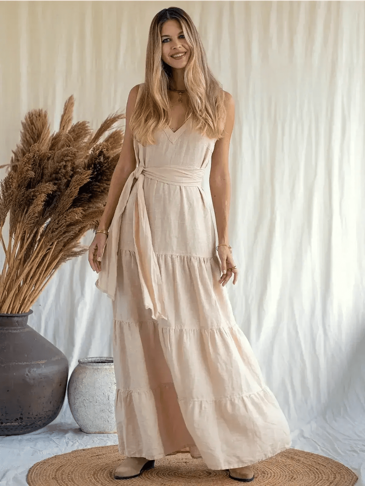 Sierra Maxi Dress in breathable linen, featuring a V-neckline and tiered A-line silhouette, perfect for warm weather.