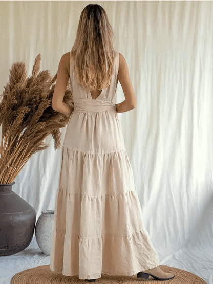 Back view of a woman wearing a Sierra Maxi Dress in breathable linen, showcasing a tiered A-line silhouette.