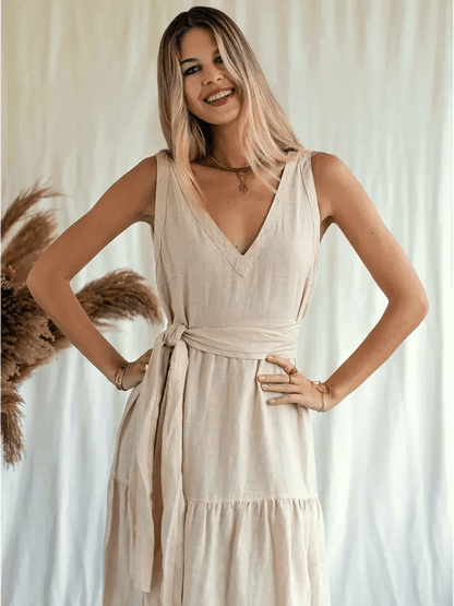 Model showcasing the Sierra Maxi Dress, a sleeveless, linen, V-neck dress with a self-tie belt, perfect for warm days.