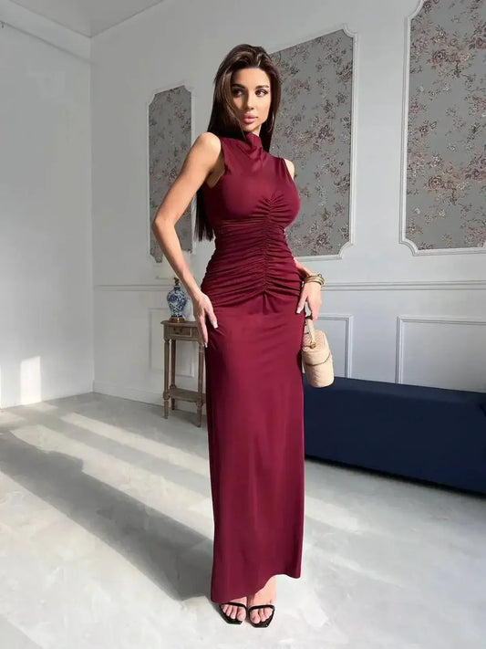 Model wearing a Silken Rush Maxi Dress in wine red, featuring a sleek silhouette and elegant ruching.