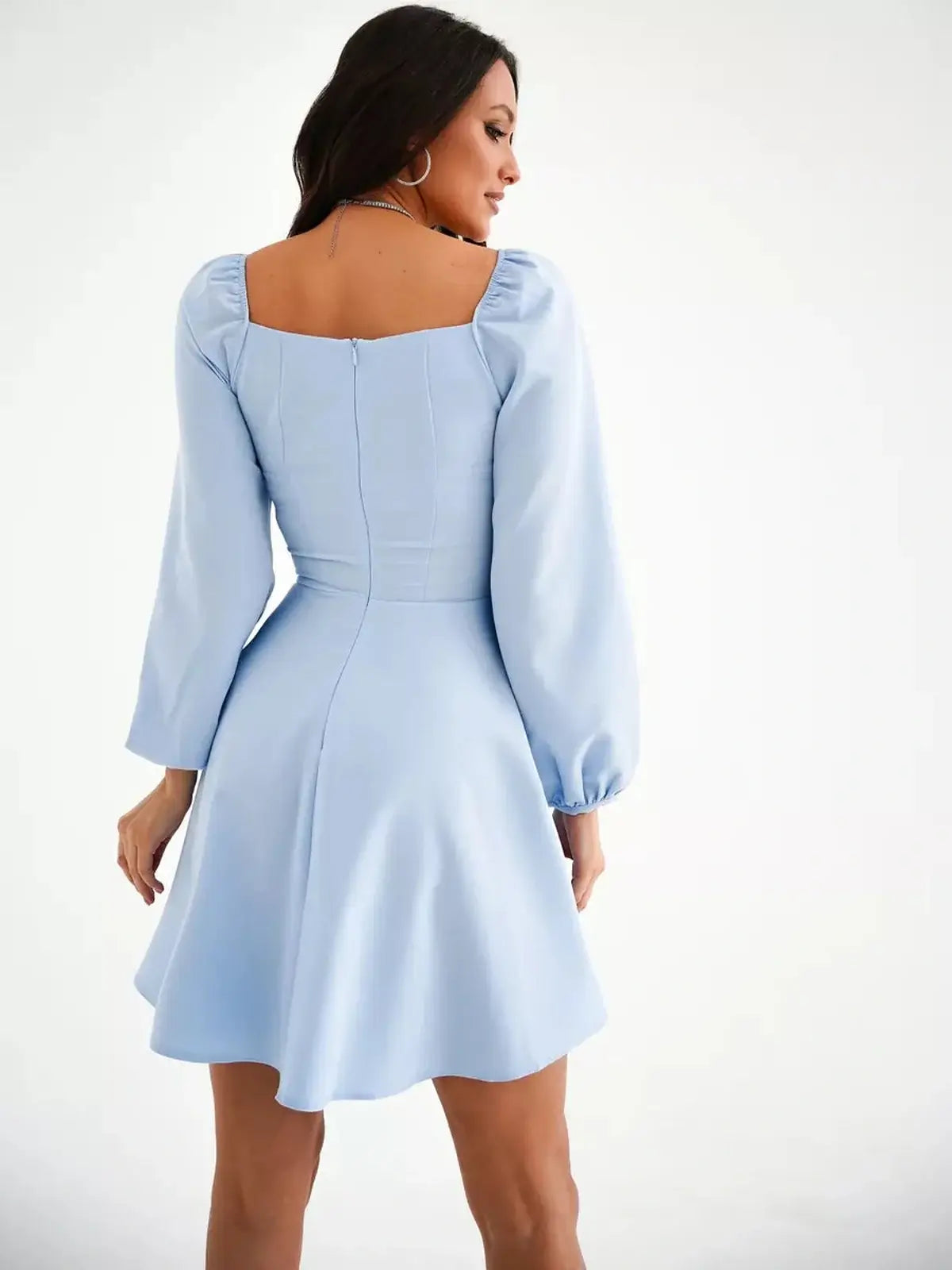 Light blue mini dress with structured square neckline and puffed long sleeves, perfect for summer events and wedding guest attire.