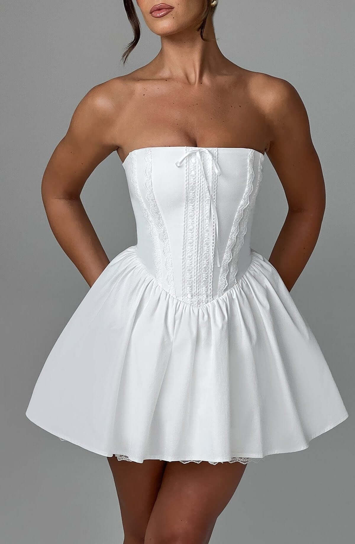 Skye Mini Dress, a strapless white corset dress featuring a flared skirt, perfect for summer, weddings, or parties.