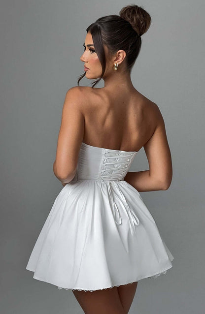 Back view of the Skye Mini Dress, a white corset mini dress for women, perfect for wedding guests and summer parties.