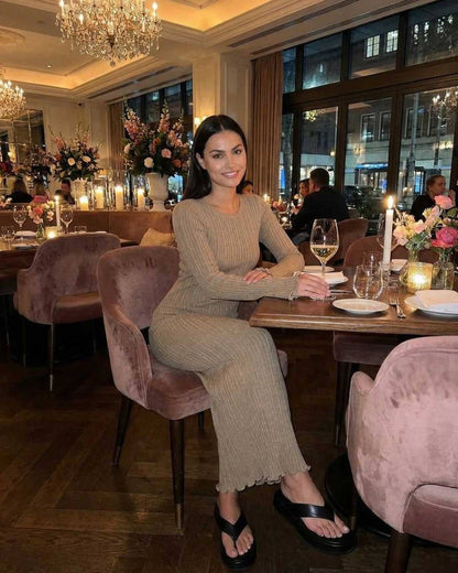 Lauven Solara Maxi Dress in warm taupe, elegant ribbed knit, perfect for a cozy dinner setting.