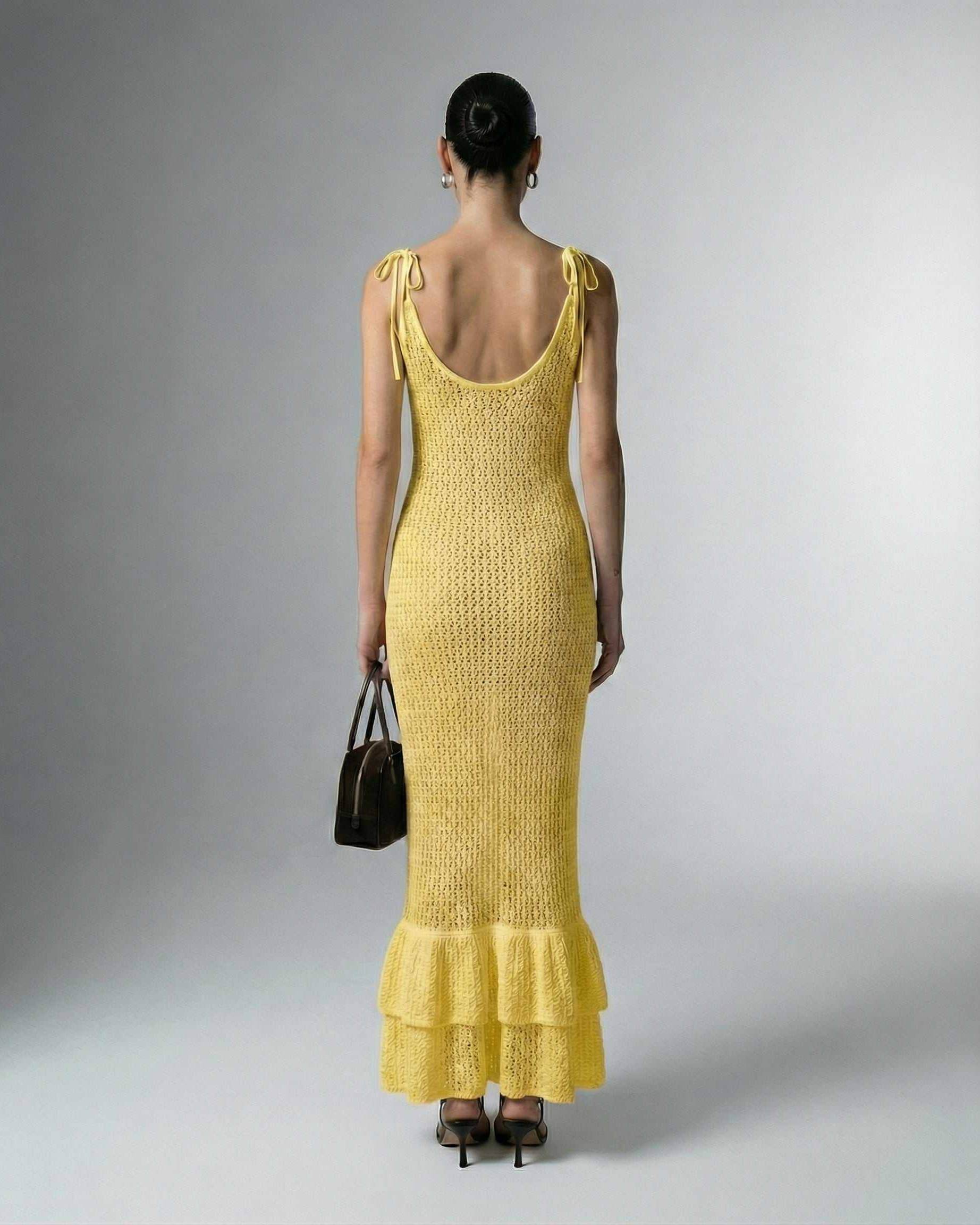 Solara Maxi Dress by Lauven, showcasing a yellow bodycon design with hollow out details and a flared hem.