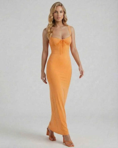 Model wearing the Lauven Soleil Maxi Dress in vibrant orange, featuring spaghetti straps and lace trim.