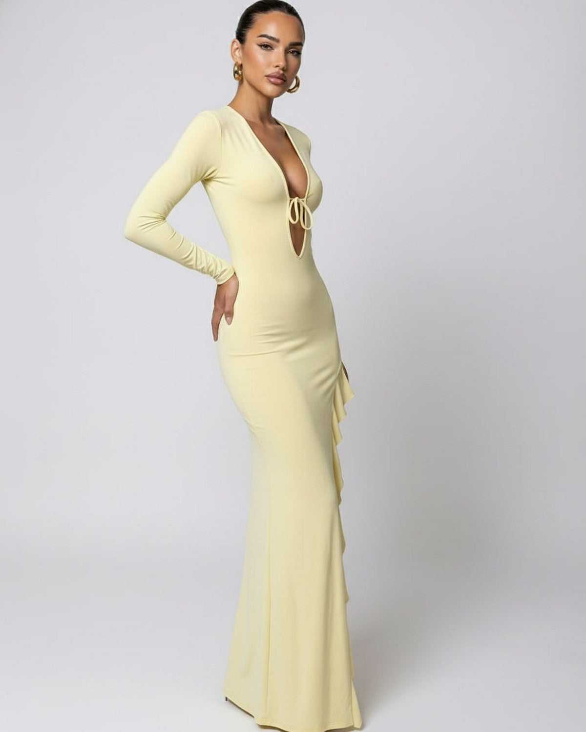 Soleil Maxi Dress showcasing a yellow deep V-neck style with ruffle high slit, featuring a refined tie detail by Lauven.