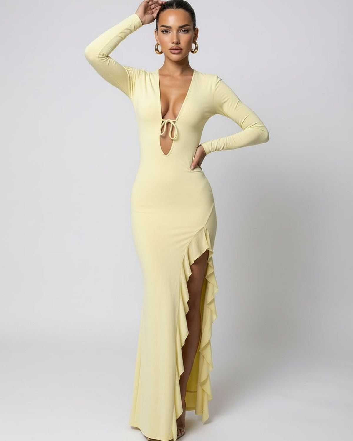 Soleil Maxi Dress featuring a deep V-neck, high ruffle slit, and long sleeves by Lauven in a soft yellow fabric.
